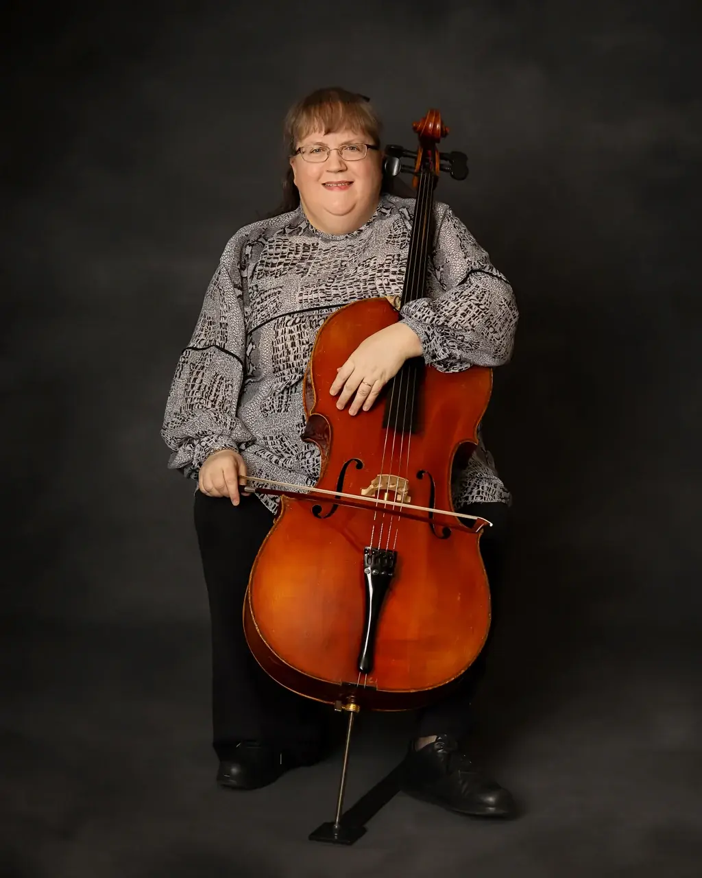Elizabeth Skola Davis seated with her cello